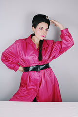 Women's vintage 1980's Windsor Bay long sleeve long length bright pink nylon and polyester button up windbreaker jacket.
