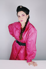Women's vintage 1980's Windsor Bay long sleeve long length bright pink nylon and polyester button up windbreaker jacket.