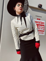 long sleeve white leather 1980's wilsons jacket with black trim and black belt asymmetrical zipper women's vintage