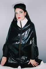 Women's vintage 1960's Aqua-Sheen by Exylin Co., Made in USA label vinyl material poncho with shiny exterior in black and white.
