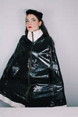 Women's vintage 1960's Aqua-Sheen by Exylin Co., Made in USA label vinyl material poncho with shiny exterior in black and white.