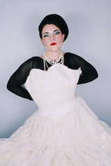 Women's vintage 1950's white lace wedding dress with cream satin bodice and lace overlay. Sweetheart neckline, strapless, zipper in the back.