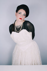 Women's vintage 1950's white lace wedding dress with cream satin bodice and lace overlay. Sweetheart neckline, strapless, zipper in the back.