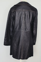 long sleeve black leather long jacket with double lapel, buttons, and white thread detail vintage 1970's