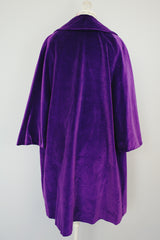 purple velvet coat with 3/4 arm length buttons up the front and attached neck tie vintage women's 1960's