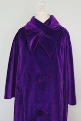 purple velvet coat with 3/4 arm length buttons up the front and attached neck tie vintage women's 1960's