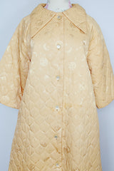gold colored quilted duster jacket buttons up the front with collar and moon and star all over print