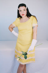 Women's vintage 1960's Miss Elliette California label short sleeve knee length yellow dress with scoop neck and cream floral applique trim.