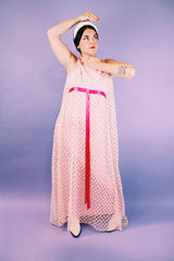 sleeveless pink dress with polka dot sheer lace overlay and ribbon around waist vintage 1960's