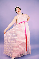 sleeveless pink dress with polka dot sheer lace overlay and ribbon around waist vintage 1960's