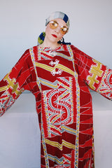 Women's vintage 1970's long sleeve printed cotton muu muu dress in red, green, grey, and white.
