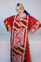 Women's vintage 1970's long sleeve printed cotton muu muu dress in red, green, grey, and white.