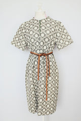 short sleeve green and cream printed knee length dress with front zipper and tie belt vintage 1970's