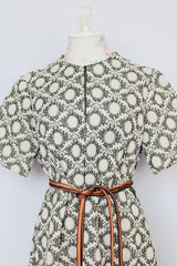 short sleeve green and cream printed knee length dress with front zipper and tie belt vintage 1970's
