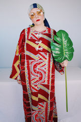 Women's vintage 1970's long sleeve printed cotton muu muu dress in red, green, grey, and white.