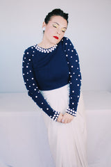 Women's vintage 1960's long sleeve midi length twofer dress with a navy cashmere top half and white polyester skirt. White beads all over top part.