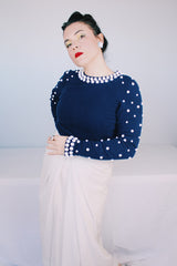 Women's vintage 1960's long sleeve midi length twofer dress with a navy cashmere top half and white polyester skirt. White beads all over top part.