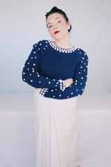 Women's vintage 1960's long sleeve midi length twofer dress with a navy cashmere top half and white polyester skirt. White beads all over top part.
