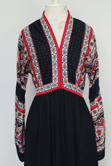 long sleeve v neck maxi dress in black with paisley print vintage 1970's