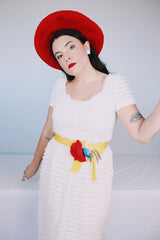 Women's vintage 1970's short sleeve maxi length white dress with tiered lace ruffles all over and an attached yellow belt with flowers