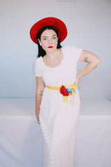 Women's vintage 1970's short sleeve maxi length white dress with tiered lace ruffles all over and an attached yellow belt with flowers