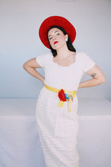 Women's vintage 1970's short sleeve maxi length white dress with tiered lace ruffles all over and an attached yellow belt with flowers