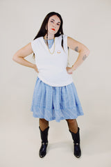 sleeveless white sweater vest with v neck with crest on left chest vintage 1970's