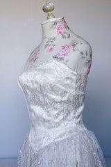Women's vintage 1950's white lace wedding dress with cream satin bodice and lace overlay. Sweetheart neckline, strapless, zipper in the back.