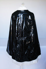 Women's vintage 1960's Aqua-Sheen by Exylin Co., Made in USA label vinyl material poncho with shiny exterior in black and white.