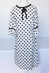Women's vintage 1960's Gallant California short sleeve white linen dress with black polka dots all over. Has black bow tie on neck.
