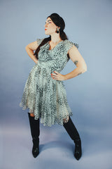 knee length sleeveless dress with ruffle neckline in a white and black polka dot print vintage 1970's