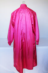 Women's vintage 1980's Windsor Bay long sleeve long length bright pink nylon and polyester button up windbreaker jacket.