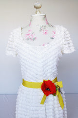 Women's vintage 1970's short sleeve maxi length white dress with tiered lace ruffles all over and an attached yellow belt with flowers