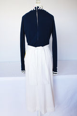Women's vintage 1960's long sleeve midi length twofer dress with a navy cashmere top half and white polyester skirt. White beads all over top part.