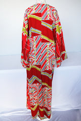 Women's vintage 1970's long sleeve printed cotton muu muu dress in red, green, grey, and white.