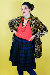 Women's vintage 1970's Lipman's Caliente Shop, Century of Boston label pleated wool knee length skirt in blue, forest green, red, and black plaid print.