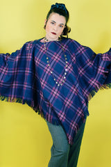 Women's vintage 1970's one size fits most navy and purple plaid print poncho with fringe hem trim and button closure on shoulder in acrylic material.
