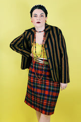 Women's vintage 1970's knee length pencil skirt in an acrylic material in red, blue, yellow, and white all over tartan plaid print.