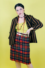 Women's vintage 1970's knee length pencil skirt in an acrylic material in red, blue, yellow, and white all over tartan plaid print.