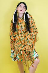 Women's vintage 1970's acrylic knit multicolored poncho with a long fringe trim hem, drawstring at neck, and V shaped neckline in orange, mustard yellow, and olive green colors.
