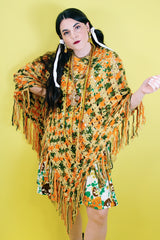 Women's vintage 1970's acrylic knit multicolored poncho with a long fringe trim hem, drawstring at neck, and V shaped neckline in orange, mustard yellow, and olive green colors.