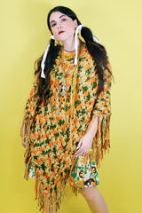 Women's vintage 1970's acrylic knit multicolored poncho with a long fringe trim hem, drawstring at neck, and V shaped neckline in orange, mustard yellow, and olive green colors.