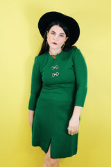Women's vintage 1960's Dalton label long sleeve knee length green wool dress with a ribbed mid section and gold hardware detail on chest.