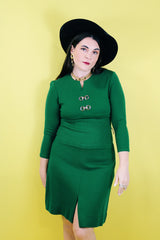 Women's vintage 1960's Dalton label long sleeve knee length green wool dress with a ribbed mid section and gold hardware detail on chest.