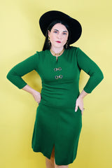 Women's vintage 1960's Dalton label long sleeve knee length green wool dress with a ribbed mid section and gold hardware detail on chest.