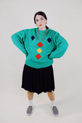long sleeve kelly green pullover sweater with navy, yellow, and red diamond pattern vintage 1980's