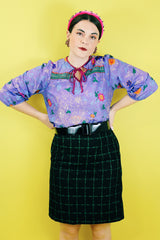 Women's vintage 1970's Made in USA label black knee length pencil skirt with bright green checkered plaid print in a wool and polyester blend material.