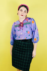 Women's vintage 1970's That's It! California label 3/4 arm length purple sheer lightweight polyester material pullover blouse in purple with all over floral print.