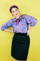 Women's vintage 1970's Made in USA label black knee length pencil skirt with bright green checkered plaid print in a wool and polyester blend material.