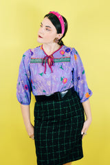 Women's vintage 1970's Made in USA label black knee length pencil skirt with bright green checkered plaid print in a wool and polyester blend material.